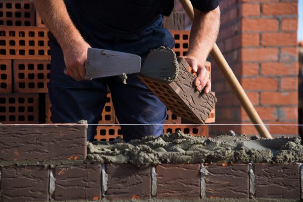 bricklayer-worker-installing-brick-masonry-on-exte-2025-10-16-22-51-32-utc